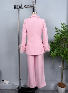 Detail view of pink women suit jacket featuring elegant feather trim on sleeves back side