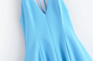 Detail shot of light blue V-neck dress featuring delicate spaghetti straps and seams
