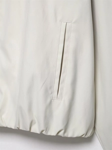 Detail of bomber jacket side pocket and elastic hem with twill fabric texture