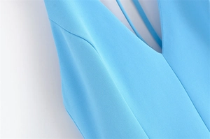 Close-up of deep V-neck and fine strap details on a sky blue dress with smooth seams