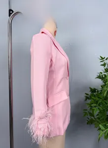 Detail of pink blazer featuring chic feather trim cuffs on long sleeves for women