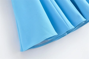 Detail view of the pleated hem on light blue spring dress showing neat stitching