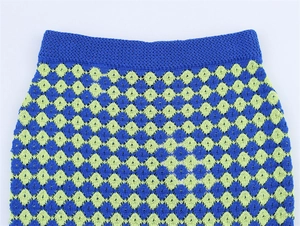 Detail of blue and green pointelle knit skirt featuring a wide elastic ribbed waistband