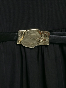 Detail of a black midi dress featuring a stylish gold irregular metal buckle on a leather belt