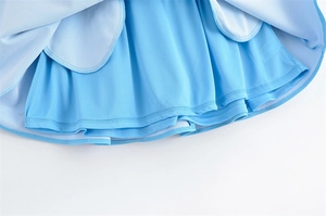 Detail of light blue pleated skirt featuring built-in safety shorts and breathable fabric