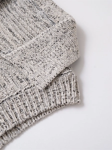 Close-up of grey marl knit fabric showing thick ribbing and soft textured weave