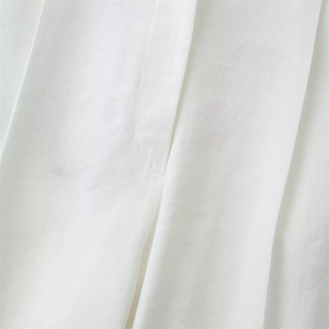 Close-up of premium white twill fabric texture showing high-quality weaving detail