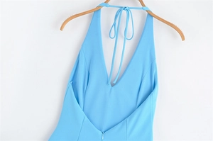 Detail of light blue halter dress showing V-back cut, texture and invisible zipper