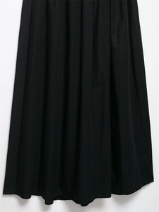 Detail of high-waist pleated midi skirt in black with premium woven fabric and smooth drape