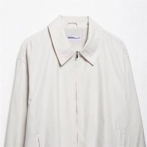 Minimalist cream white bomber jacket for women featuring a collar and front zipper closure