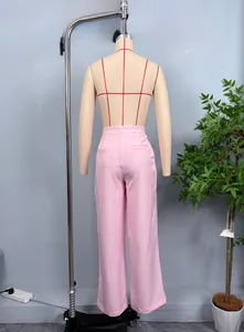 Detail of light pink high-waisted wide-leg trousers with elegant tailored draping effect