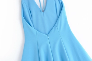 Detail of light blue dress showing V-neck back design and invisible zipper closure