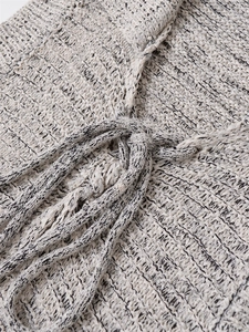 Detailed close-up of breathable crochet knit texture with stylish waist tie drawstring