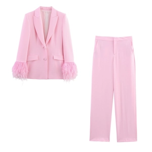 Detail of pink suit jacket showing stylish sleeve cuffs with dense feather fringe decor