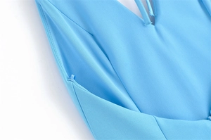 Detailed close-up of light blue V-neck dress with fine stitching and inner hanging straps