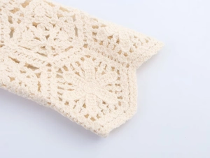 Detailed macro shot of the off-white crochet floral pattern and intricate knit texture