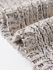 Detailed macro view of the textured wave pattern knit fabric on this sleeveless dress