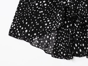 Detail of polka dot chiffon fabric with ruffled layers and clean hem stitching