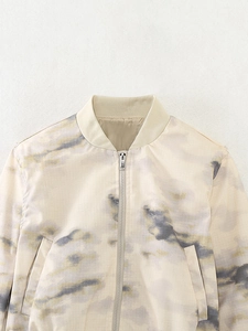 Detailed view of women's bomber jacket with marble print and ribbed stand collar design
