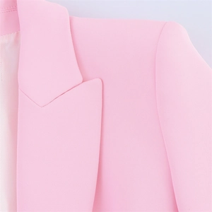 Detailed view of pink blazer lapel with high-quality stitching and striped lining