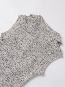 Close-up of grey and white knit fabric texture and ribbed collar on a sleeveless dress