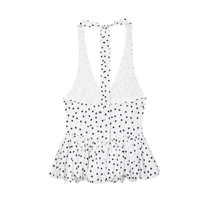 Detailed view of the white polka dot halter top with peplum hem and deep V-neckline