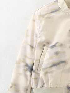 Detail of bomber jacket showing checkered texture fabric and rib-knit stand-up collar