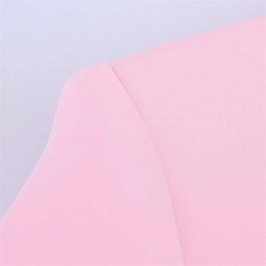 Close-up of pink blazer shoulder seam showing high-quality stitching and smooth fabric