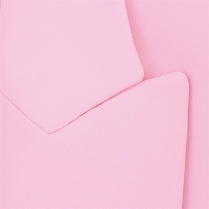 Close-up of pink blazer notched lapel showing refined stitching and fabric texture