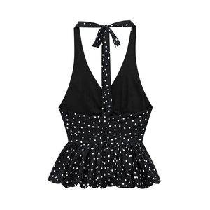 Detail of halter neck polka dot top with deep V-neck and peplum ruffle hemline