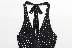 Detailed view of backless halter neck top with white polka dots and adjustable bow tie