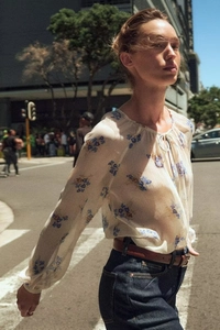 Close-up of floral print chiffon shirt with neck tie and lightweight fabric detail