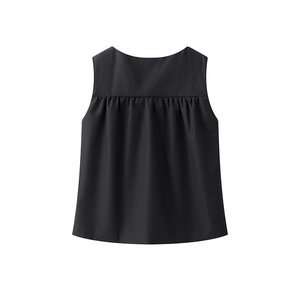 Detail of black sleeveless top with pleated chest design and elegant A-line silhouette