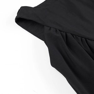 Detail showing the pleated texture and crossover design of the black women's tank top