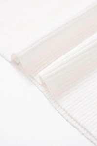 Detailed macro view of white rib-knit fabric texture on the casual spring sweater