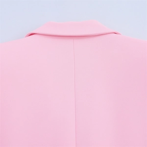 Detail view of pink suit jacket collar and back seam with professional sewing finish