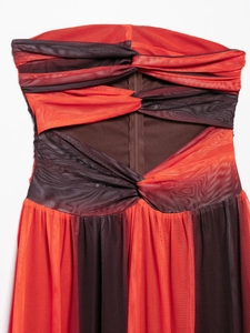 Detail of red and purple mesh dress featuring cross-pleated fabric and hidden back zipper