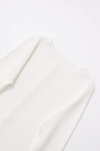 Close-up of white ribbed knit fabric showing detailed vertical texture and soft material