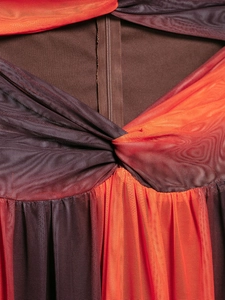 Detailed macro view of vibrant orange mesh dress with twist knot waist and invisible zipper