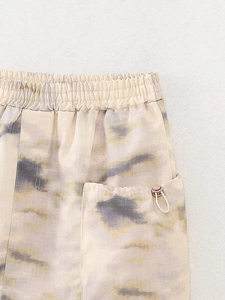 Macro detail of ripstop camo pants with elastic waist and drawstring pocket