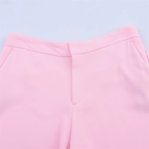 Detail view of pink suit trousers featuring a clean waistline and seamless hidden fly design