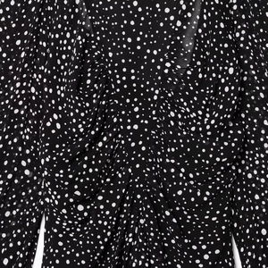 Elegant black and white polka dot chiffon dress featuring a pleated V-neckline and long sleeves