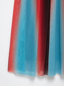 Detailed close-up of gradient mesh fabric with red and blue vertical stripe patterns