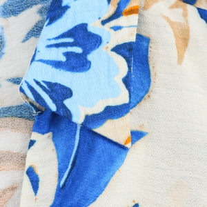 Detail of floral print fabric with blue and khaki patterns and premium stitching