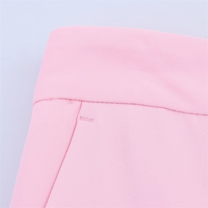 Detail of premium pink suit trousers featuring precise stitching and high-quality fabric texture