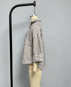 Detail view of striped shirt featuring a stylish lapel collar and wide cuffs design