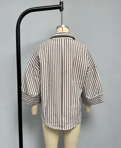 Detail of grey striped shirt featuring drop shoulders and wide cuffs for women