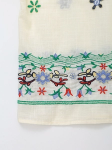 Detailaufnahme der bunten Blumenstickerei auf hochwertigem Leinenmischgewebe mit Textur
