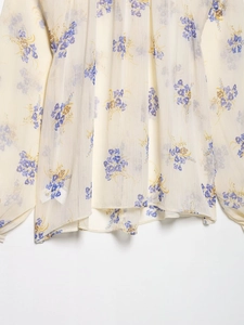 Close-up of lightweight chiffon fabric with delicate lavender floral print and textures