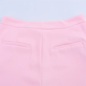 Detail of pink suit pants featuring professional welt pockets and refined stitching